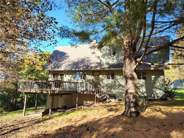 rear view of property featuring a deck