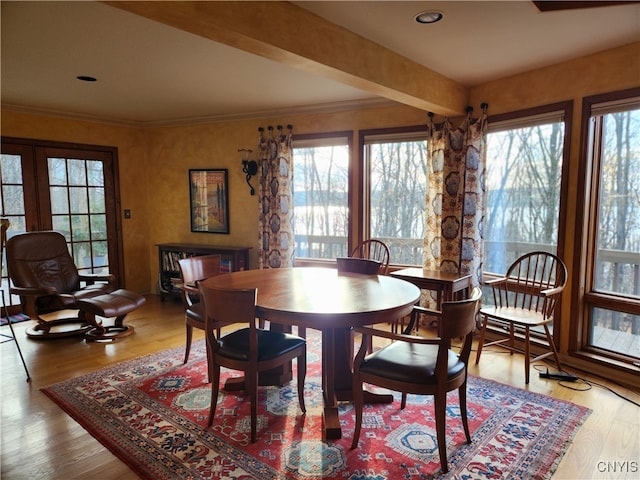 dining room featuring crown molding and light hardwood / wood-style floors