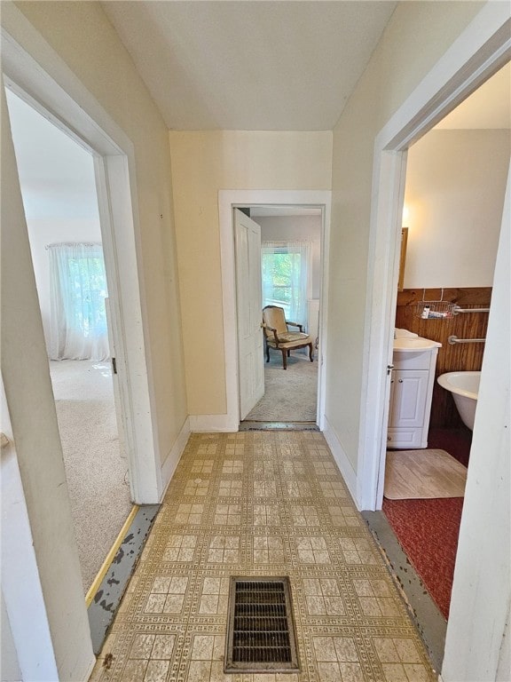 18 Wheeler St, Deposit, NY 13754 - hallway with light floors, visible vents, and wainscoting