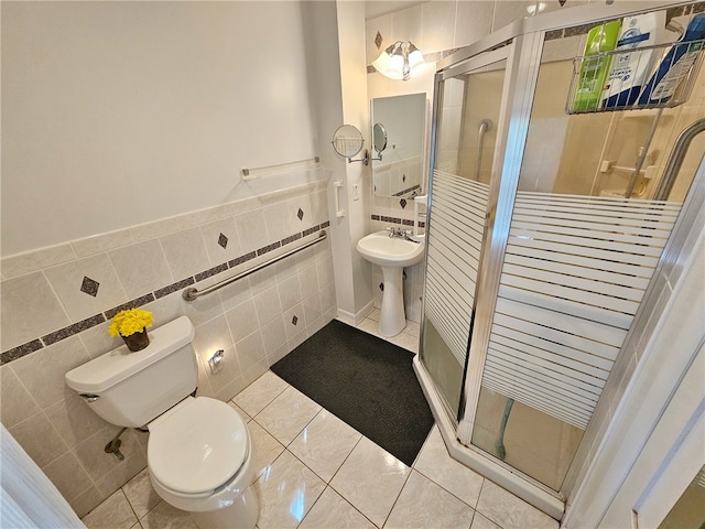18 Wheeler St, Deposit, NY 13754 - bathroom with a stall shower, tile walls, toilet, tile patterned floors, and a sink