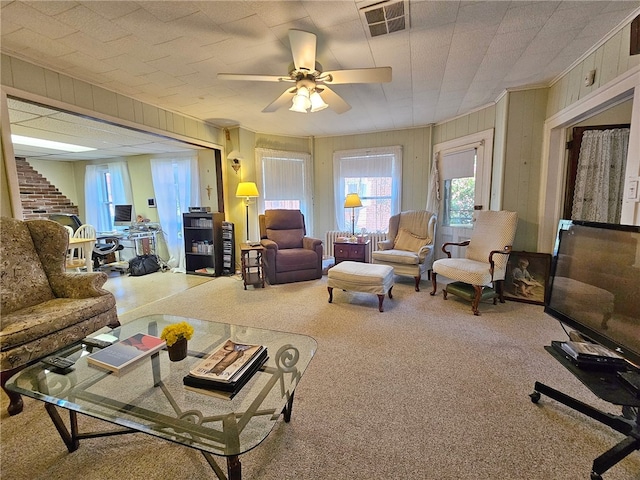 18 Wheeler St, Deposit, NY 13754 - living room featuring ceiling fan, carpet flooring, visible vents, and wooden walls