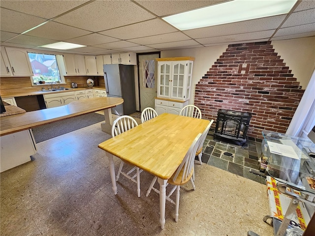 18 Wheeler St, Deposit, NY 13754 - dining room with a wood stove, a drop ceiling, and tile patterned floors
