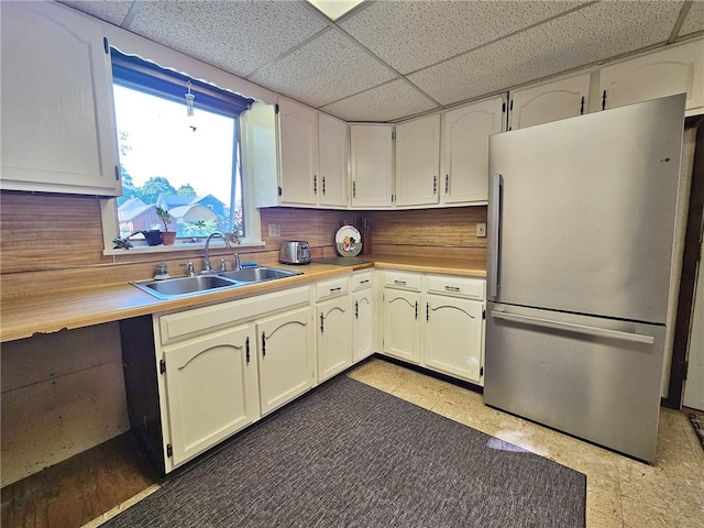 18 Wheeler St, Deposit, NY 13754 - kitchen featuring a drop ceiling, freestanding refrigerator, light countertops, light floors, and a sink