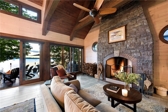 living room with ceiling fan, wooden ceiling, a water view, hardwood / wood-style flooring, and beamed ceiling