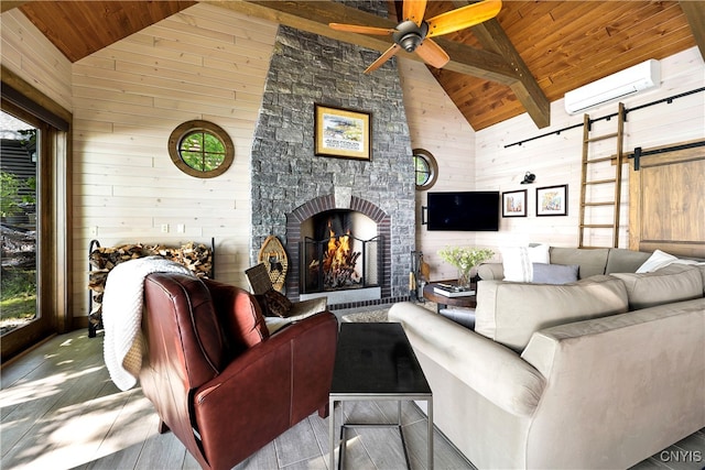 living room with an AC wall unit, wooden walls, a barn door, and wood ceiling