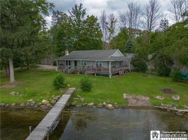 back of house featuring a deck with water view and a yard