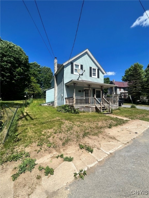 view of front of home featuring covered porch and a front lawn