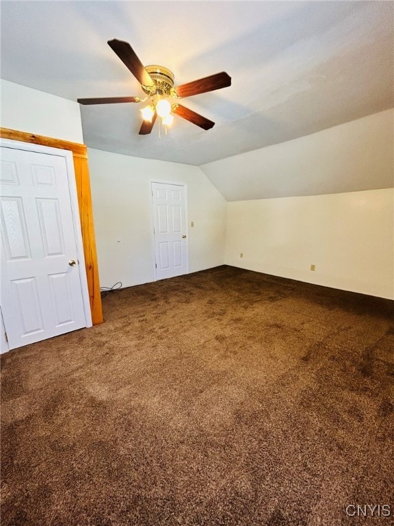 additional living space with ceiling fan, vaulted ceiling, and carpet flooring