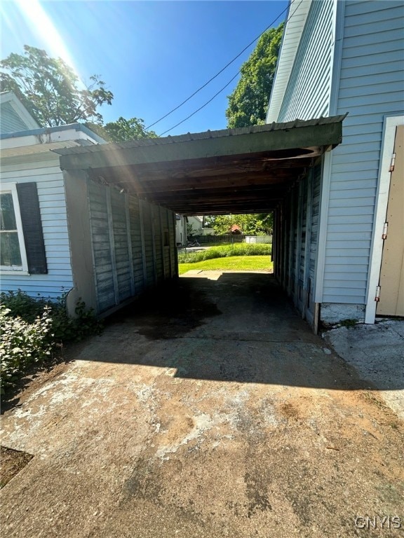 view of vehicle parking featuring a carport