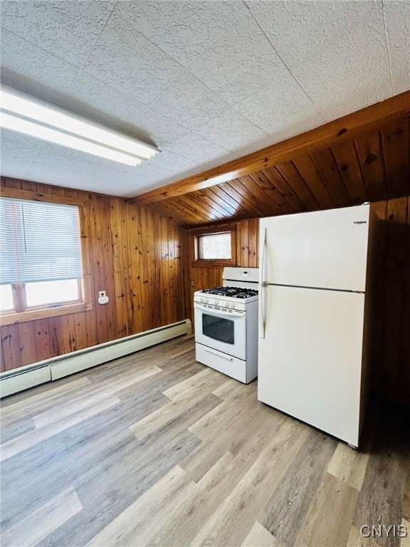 kitchen featuring wood walls, light hardwood / wood-style flooring, a baseboard radiator, and white appliances