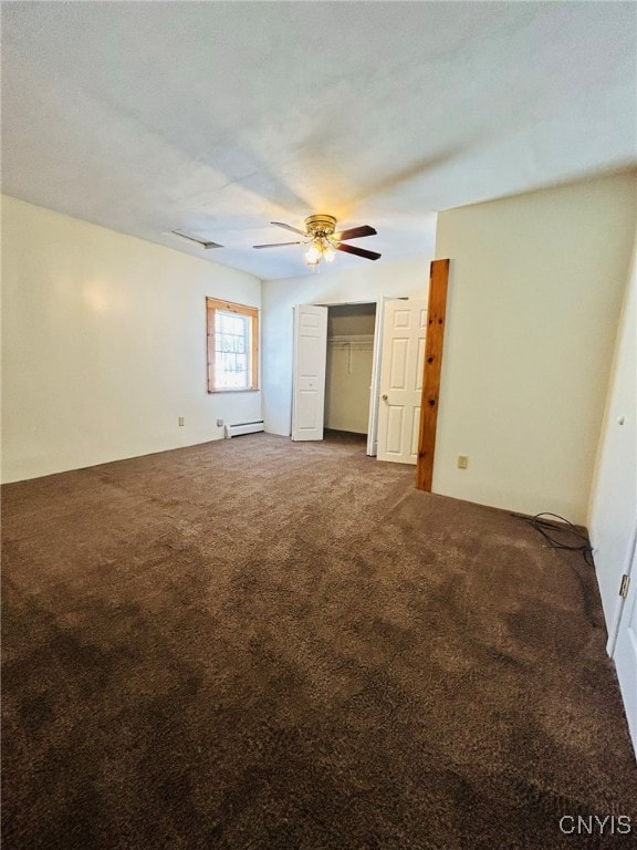 carpeted empty room featuring baseboard heating and ceiling fan