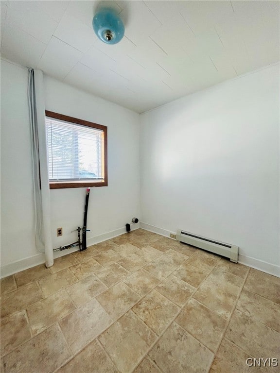 tiled empty room with a baseboard radiator