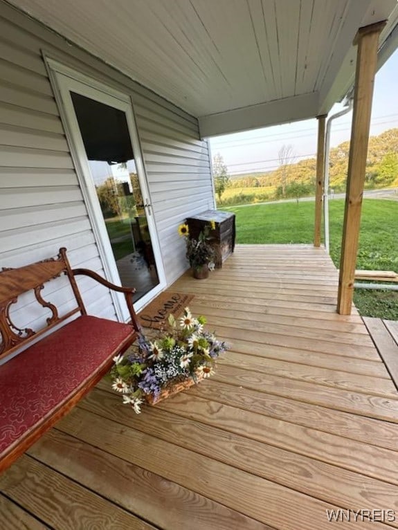 wooden terrace with a lawn