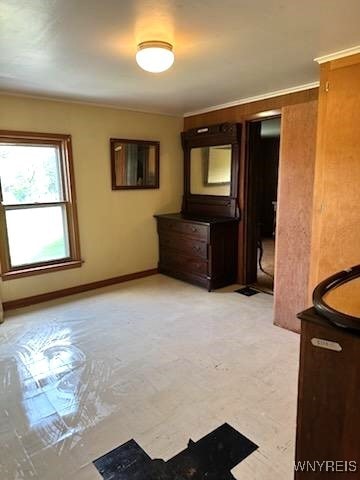 unfurnished bedroom with ornamental molding and light colored carpet