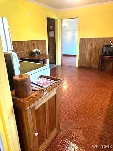 misc room featuring wooden walls and crown molding