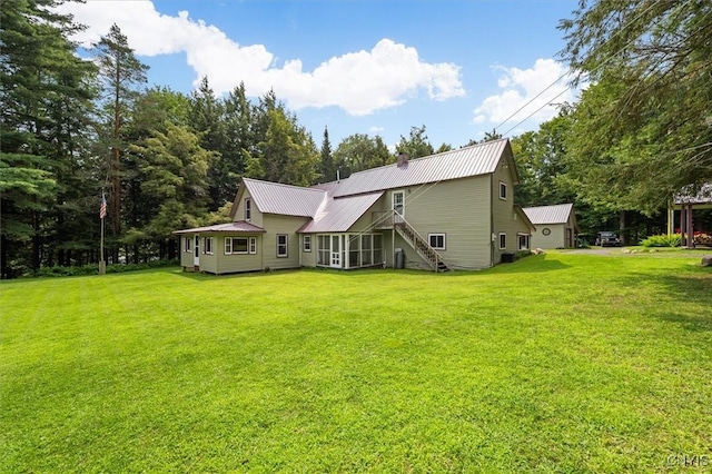 rear view of property with a lawn