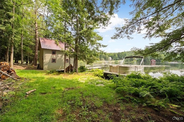 view of yard with a shed and a water view