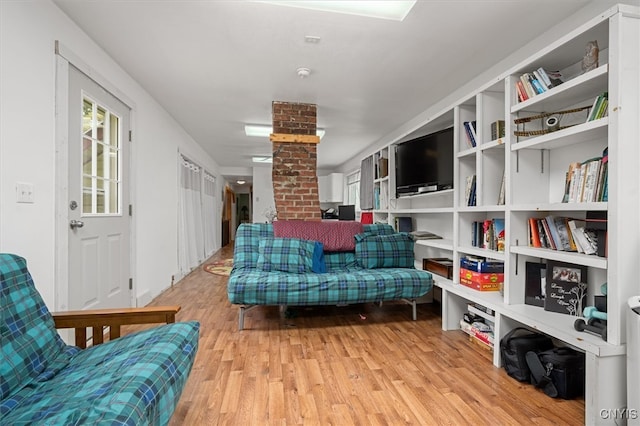 sitting room with light hardwood / wood-style flooring and decorative columns