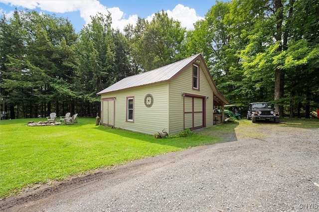 view of outdoor structure with a yard and a garage