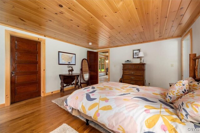 bedroom featuring wooden ceiling, ornamental molding, and light hardwood / wood-style flooring