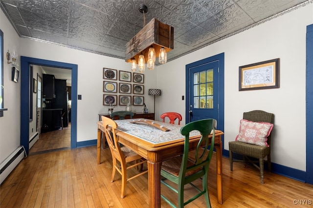 dining area with baseboard heating and wood-type flooring