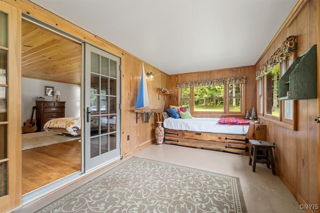 bedroom featuring wood walls