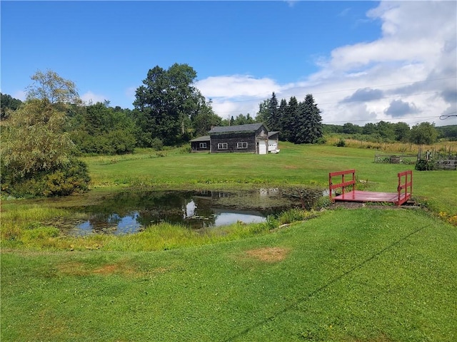 view of yard featuring an outbuilding and a water view