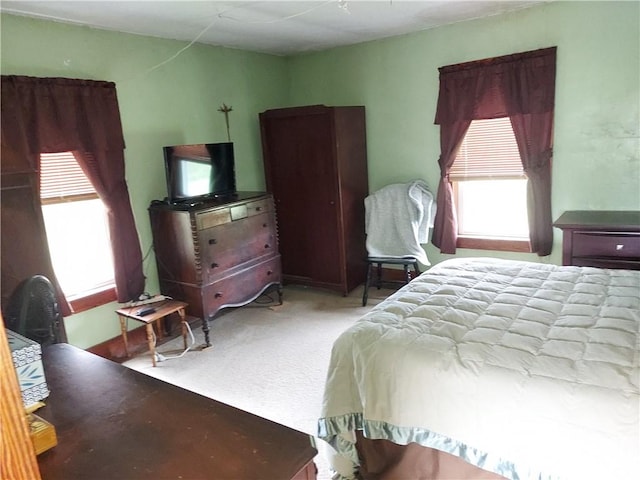 bedroom featuring light colored carpet