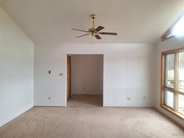 empty room featuring light colored carpet, ceiling fan, and lofted ceiling