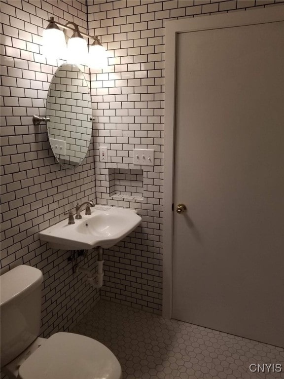 bathroom with tile patterned floors, toilet, and sink