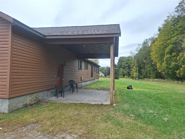 view of yard with a carport and a patio area