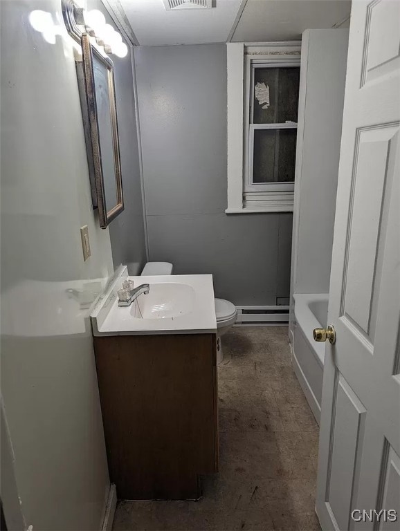 full bathroom with tub / shower combination, baseboard heating, vanity, and toilet