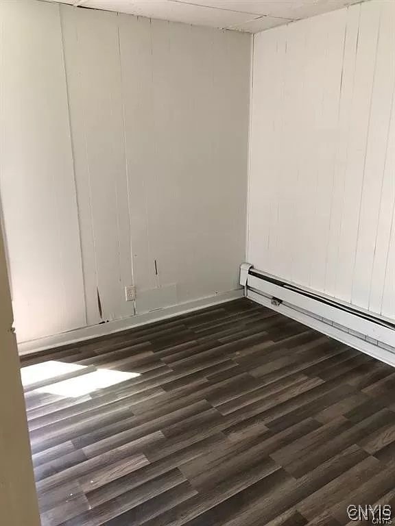 spare room featuring wood-type flooring