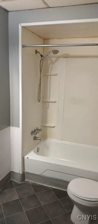 bathroom featuring toilet, tile patterned floors, and  shower combination