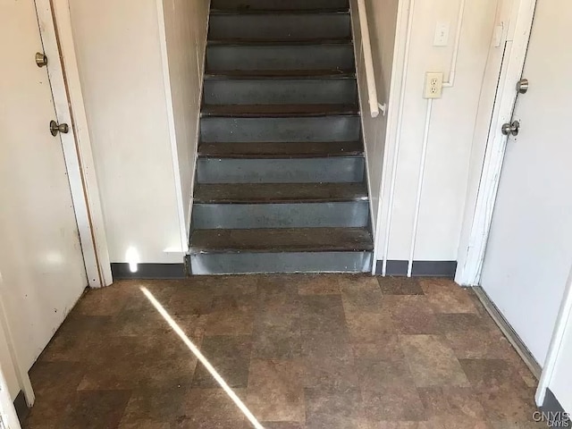 stairway featuring tile patterned flooring