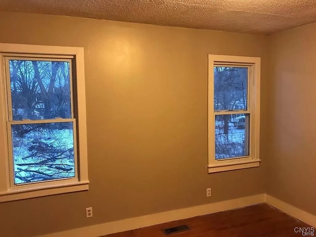 empty room featuring a textured ceiling