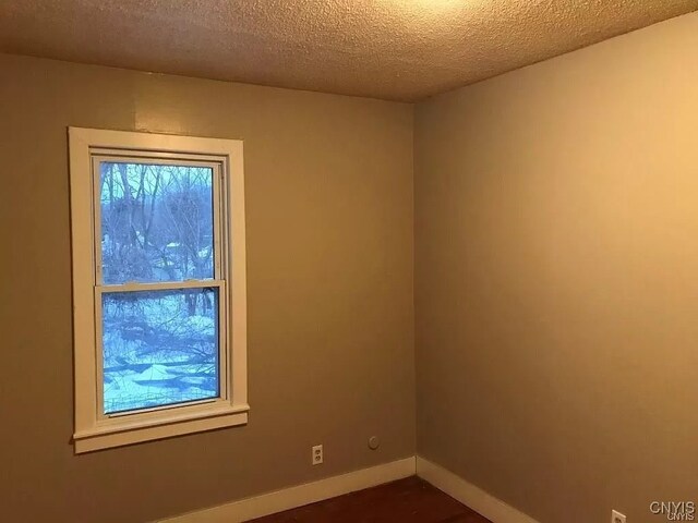 empty room with a textured ceiling