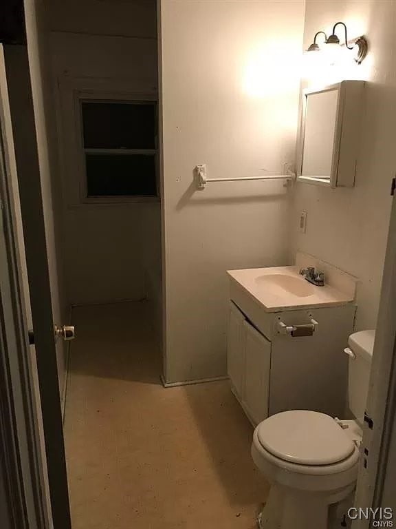 bathroom featuring vanity and toilet