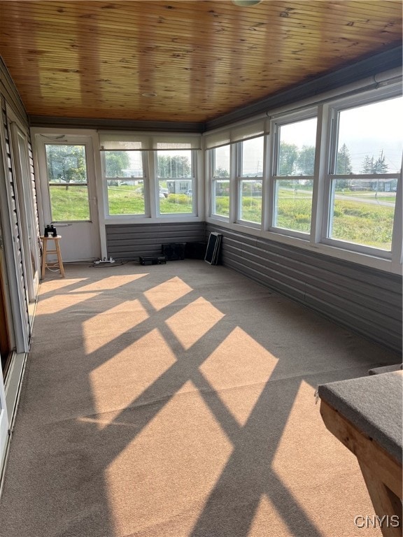 unfurnished sunroom with wooden ceiling