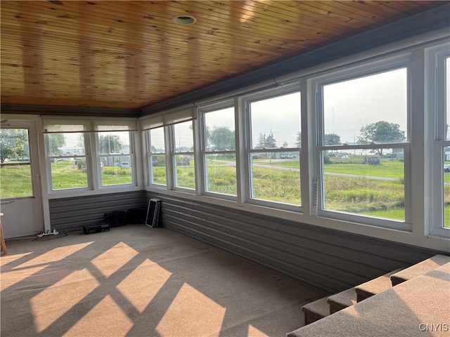 unfurnished sunroom featuring wood ceiling