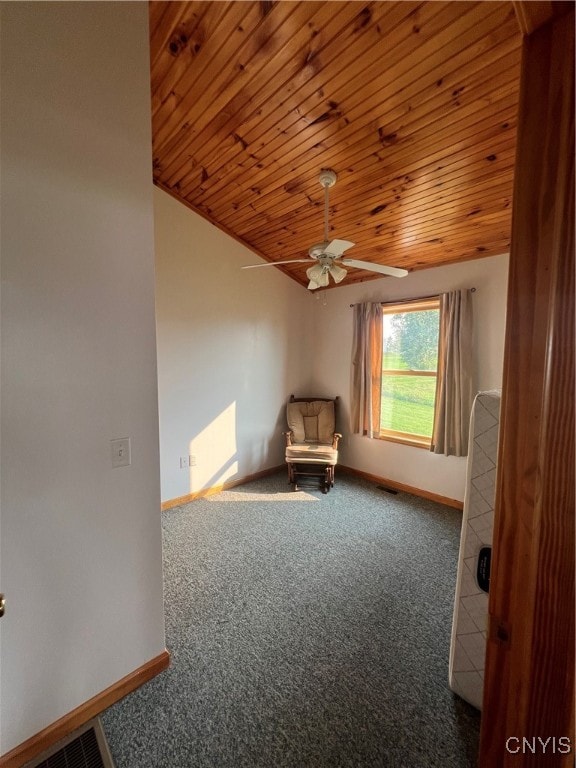 interior space featuring ceiling fan, carpet flooring, and wooden ceiling