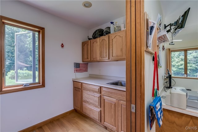 kitchen with plenty of natural light and light hardwood / wood-style floors