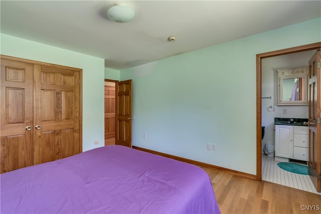 bedroom with sink, light tile patterned flooring, and a closet