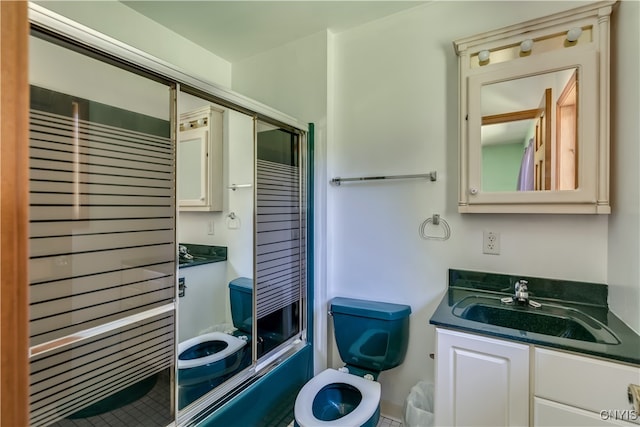 full bathroom with combined bath / shower with glass door, toilet, and vanity