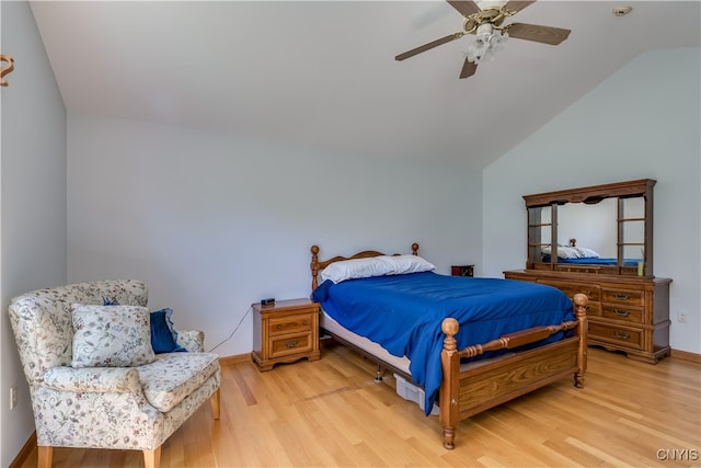 bedroom featuring light hardwood / wood-style flooring, vaulted ceiling, and ceiling fan