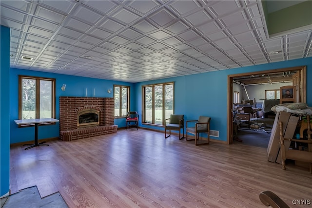 unfurnished living room featuring a fireplace and wood-type flooring