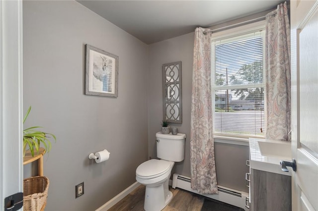 bathroom with hardwood / wood-style floors, sink, toilet, and baseboard heating