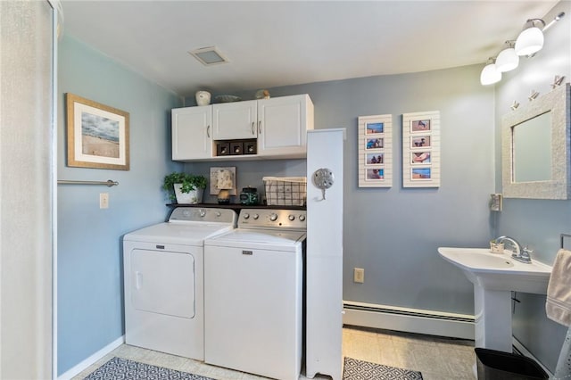 washroom featuring washer and clothes dryer and a baseboard heating unit