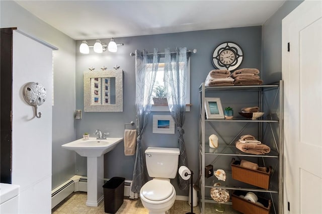 bathroom featuring a baseboard radiator and toilet