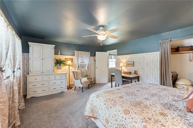 bedroom featuring cooling unit, light colored carpet, ceiling fan, and baseboard heating